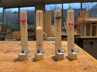 Multiple 3D printed ENdose prototypes on workbench (photo)